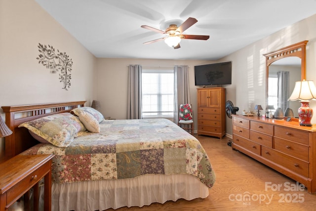 bedroom with ceiling fan and light wood-type flooring