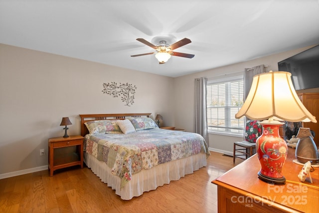 bedroom with light hardwood / wood-style flooring and ceiling fan