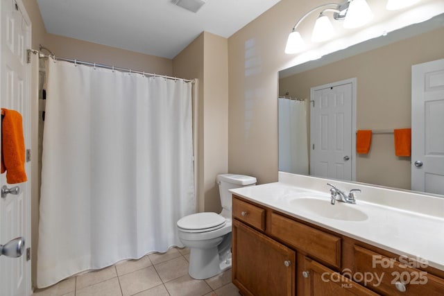 bathroom featuring vanity, tile patterned floors, and toilet