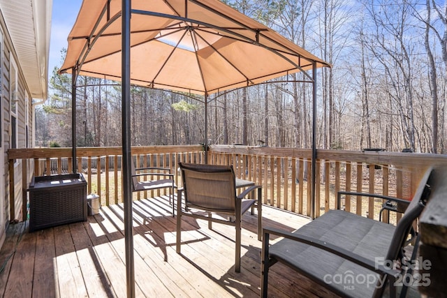 wooden terrace featuring a gazebo