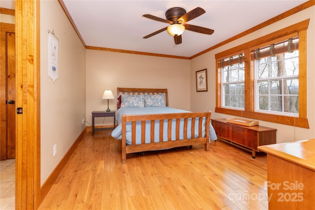 bedroom featuring crown molding, ceiling fan, and light wood-type flooring