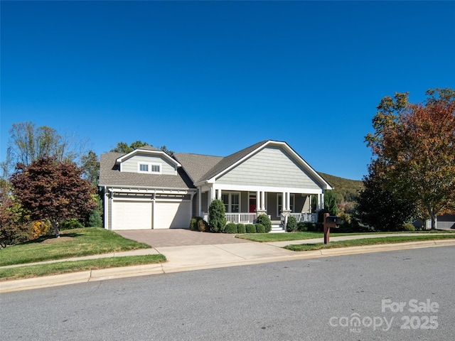 view of front facade with a garage and covered porch