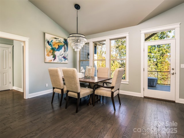 dining room featuring vaulted ceiling, dark wood-type flooring, and a chandelier