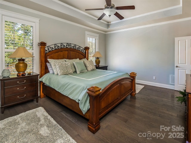 bedroom with ceiling fan, ornamental molding, and a tray ceiling