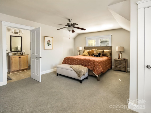 bedroom with vaulted ceiling, sink, light colored carpet, and ceiling fan