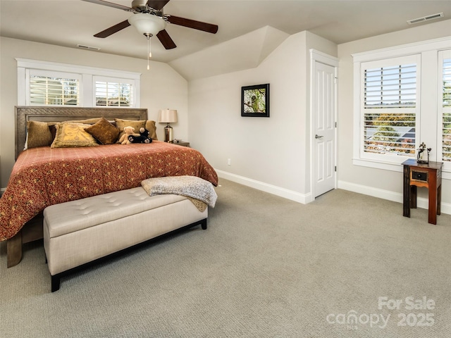 bedroom featuring multiple windows, ceiling fan, vaulted ceiling, and carpet