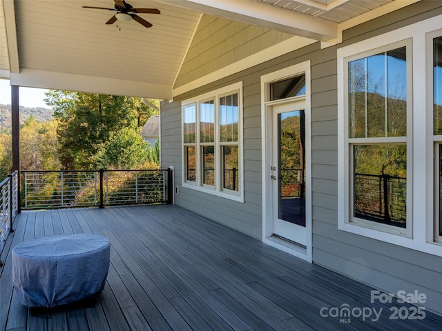 wooden terrace featuring ceiling fan