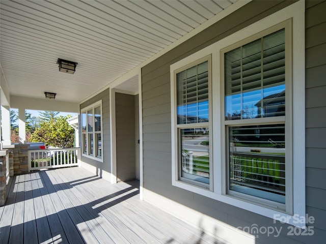 wooden terrace with a porch