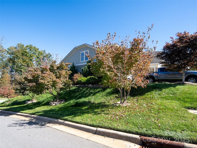 view of property exterior featuring a lawn