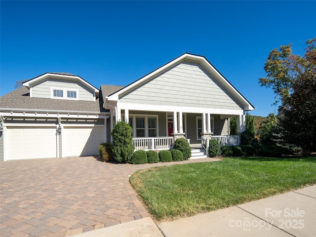 view of front facade featuring a garage, a porch, and a front yard