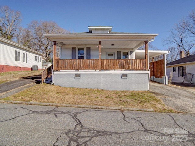 view of front of house with a porch and central air condition unit