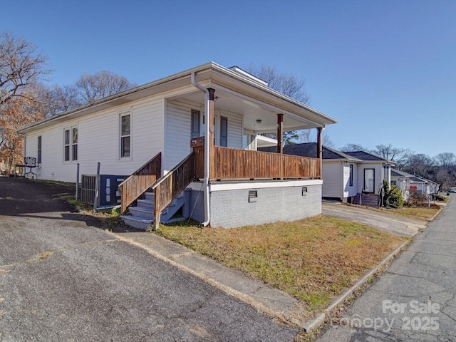 view of side of home with covered porch