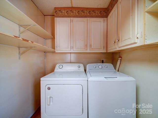 washroom featuring cabinets and independent washer and dryer