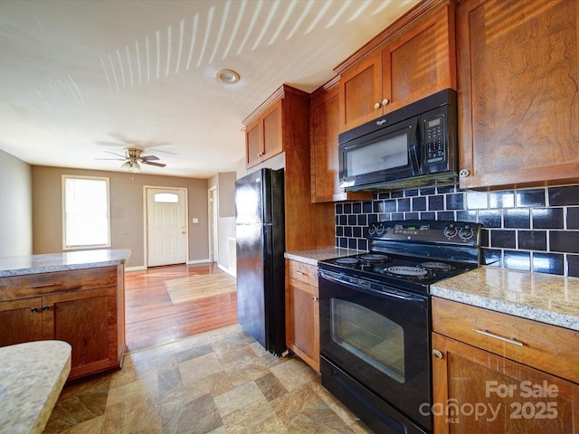 kitchen with backsplash, black appliances, ceiling fan, and light stone countertops