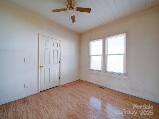 empty room featuring ceiling fan, ornamental molding, and light hardwood / wood-style floors