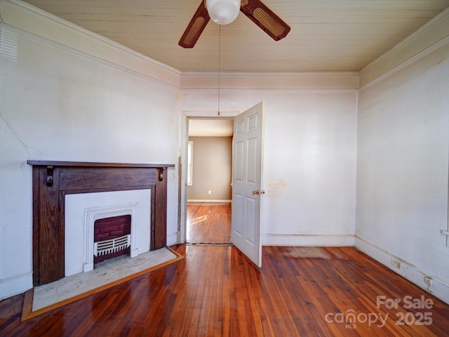 unfurnished living room featuring dark wood-type flooring, ceiling fan, and crown molding