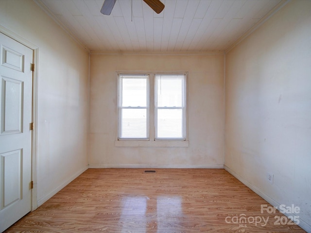 unfurnished room with crown molding, wood ceiling, ceiling fan, and light hardwood / wood-style flooring