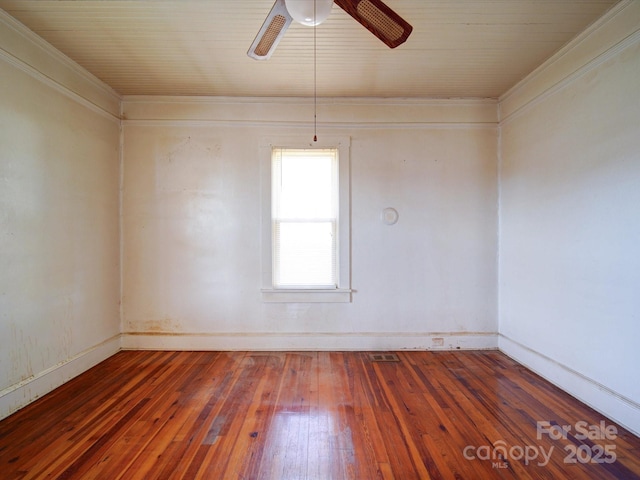 empty room featuring ceiling fan, ornamental molding, and dark hardwood / wood-style floors