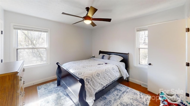 bedroom with hardwood / wood-style floors and ceiling fan