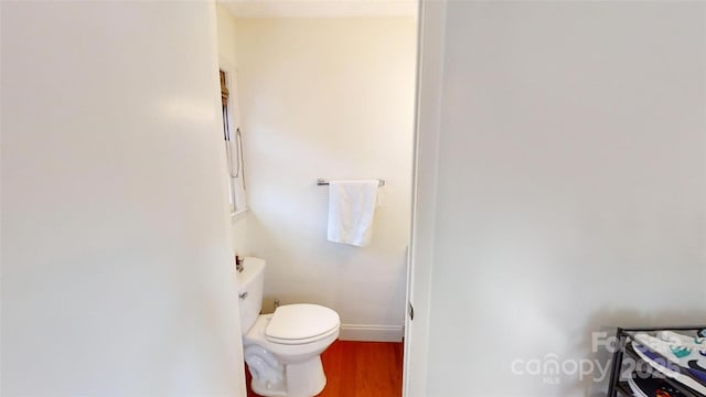 bathroom with wood-type flooring and toilet