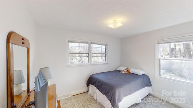 bedroom featuring multiple windows