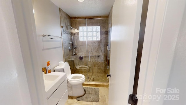 bathroom with vanity, toilet, and walk in shower