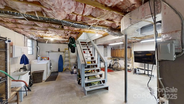 basement with washing machine and dryer and electric panel