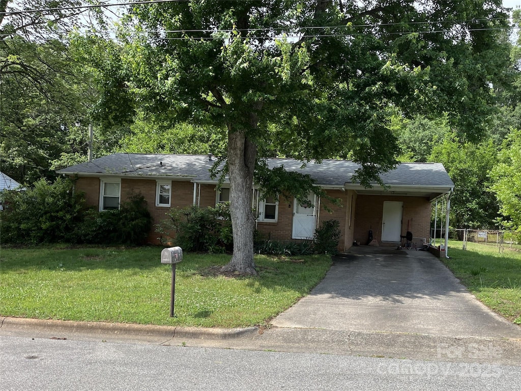 single story home with a front yard and a carport