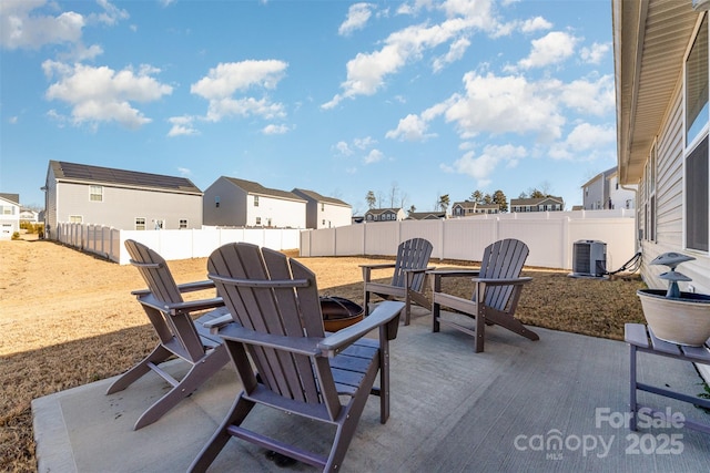 view of patio / terrace featuring central AC and a fire pit