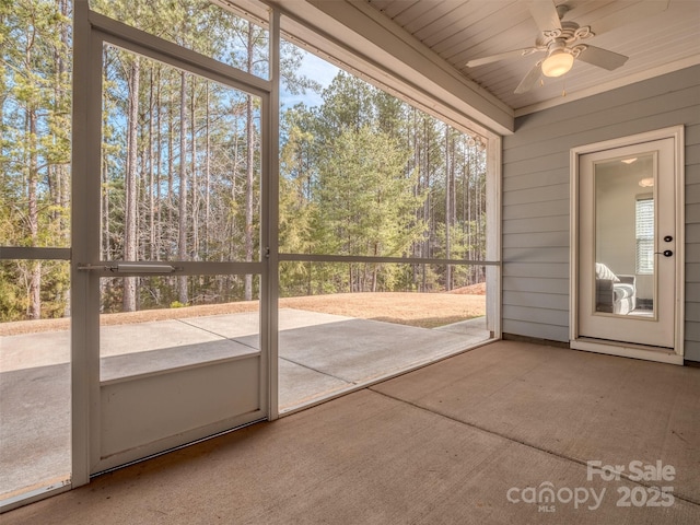 unfurnished sunroom with ceiling fan and a healthy amount of sunlight