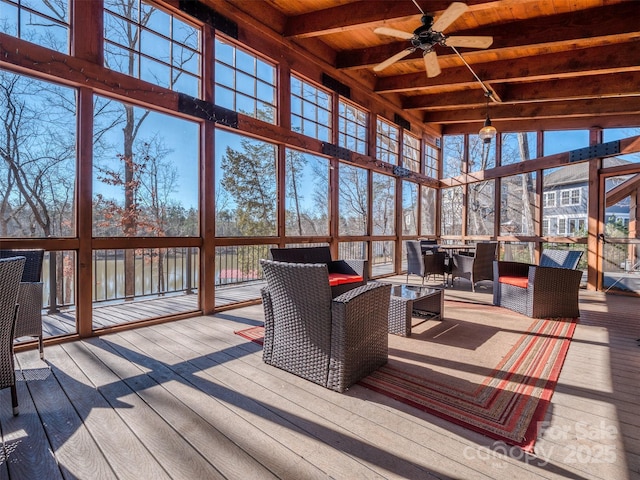 sunroom / solarium with beamed ceiling, ceiling fan, and wood ceiling