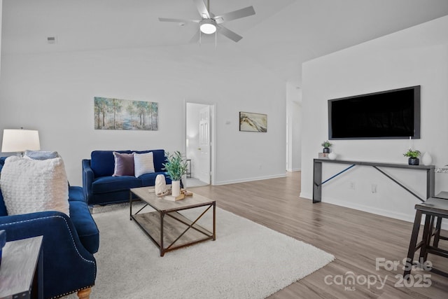 living room with hardwood / wood-style flooring, vaulted ceiling, and ceiling fan