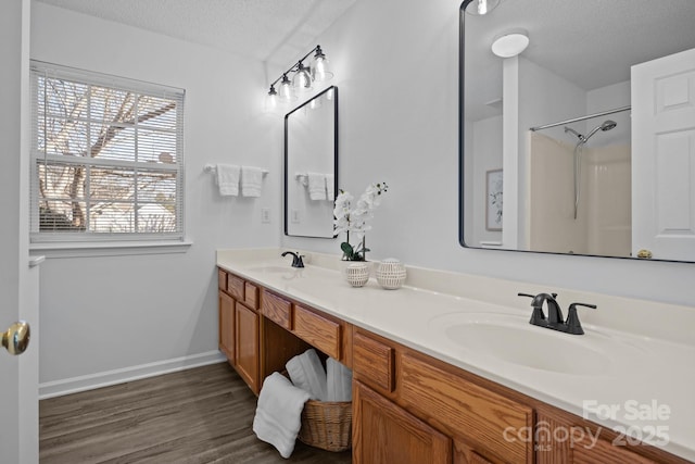 bathroom with vanity, hardwood / wood-style floors, and a textured ceiling