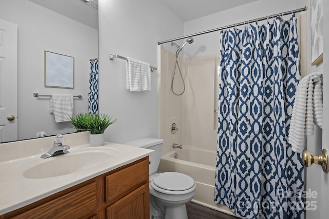 full bathroom featuring shower / bath combo, vanity, and toilet