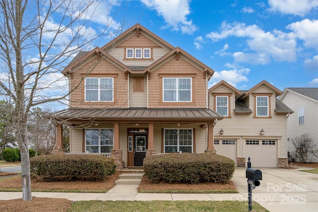 craftsman inspired home featuring a garage and covered porch