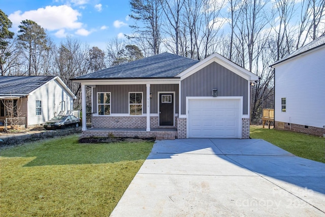 view of front facade featuring a garage, covered porch, and a front lawn