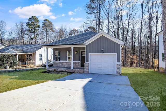 ranch-style house with a garage, a front lawn, and covered porch