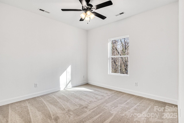 unfurnished room with light colored carpet and ceiling fan