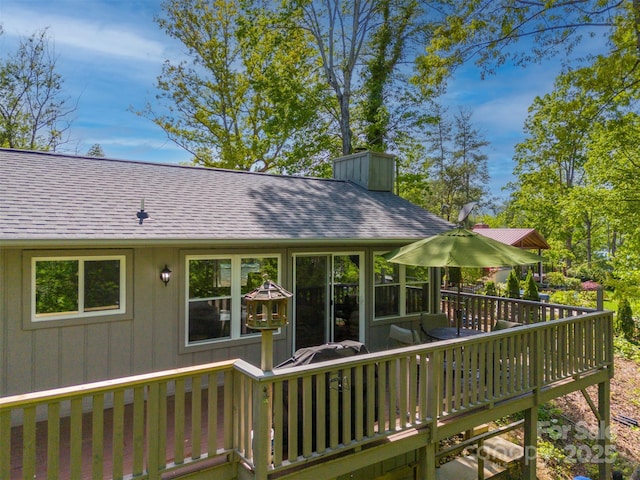 back of house featuring a wooden deck