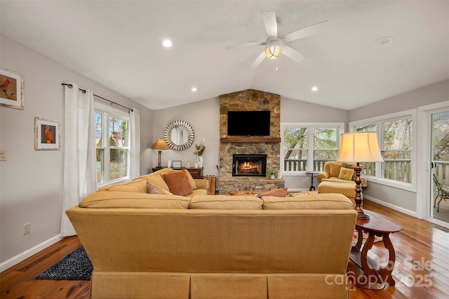 living room featuring wood-type flooring, vaulted ceiling, and a wealth of natural light