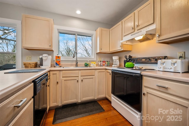 kitchen with sink, electric range oven, black dishwasher, wood-type flooring, and light brown cabinetry