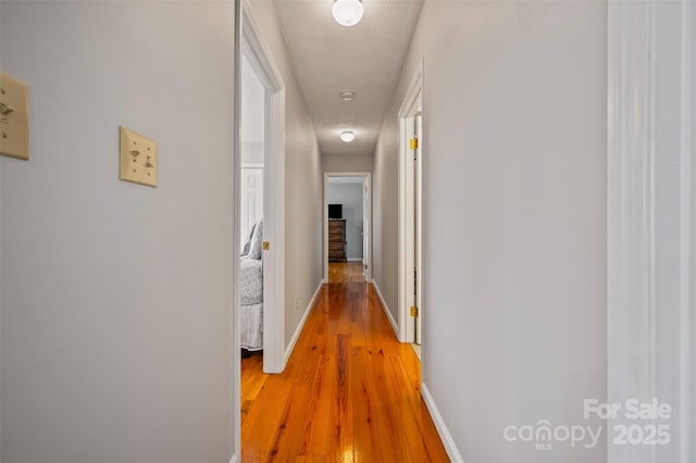 hall with hardwood / wood-style flooring and a textured ceiling