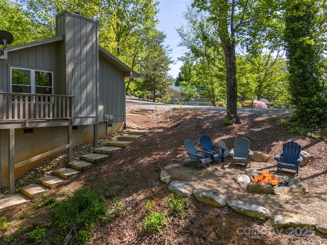 view of yard with an outdoor fire pit