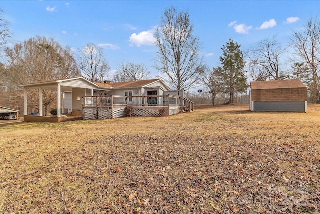 view of yard featuring a wooden deck and a storage unit