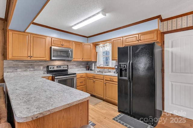 kitchen featuring stainless steel appliances, crown molding, sink, and kitchen peninsula