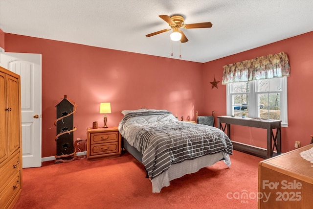 carpeted bedroom featuring ceiling fan and a textured ceiling