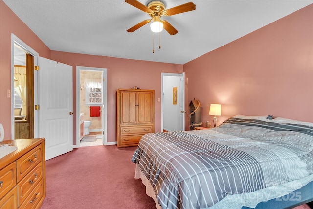 bedroom with carpet, connected bathroom, and ceiling fan