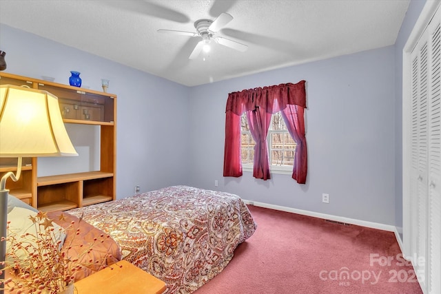 bedroom featuring ceiling fan, carpet, a textured ceiling, and a closet