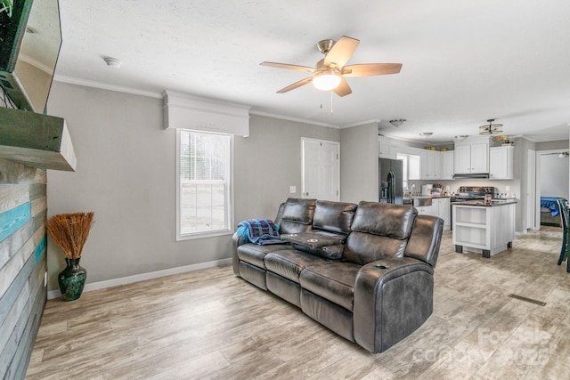 living room featuring ornamental molding, ceiling fan, and light hardwood / wood-style floors