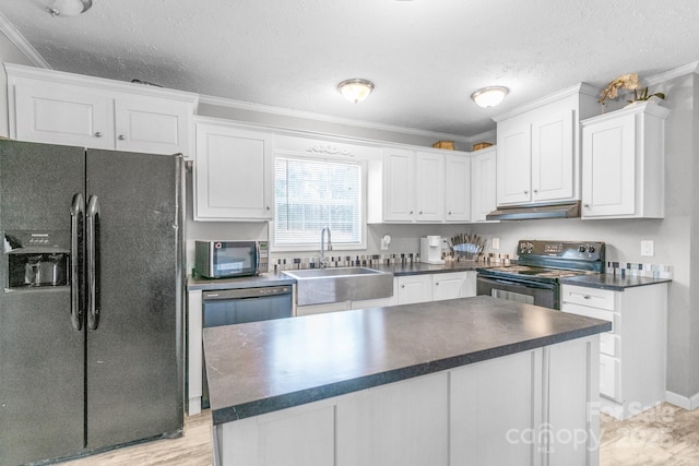 kitchen featuring sink, white cabinetry, ornamental molding, black appliances, and a kitchen island